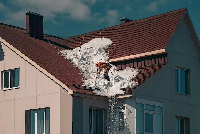 Industrial climber repairing a roof on a high-rise building